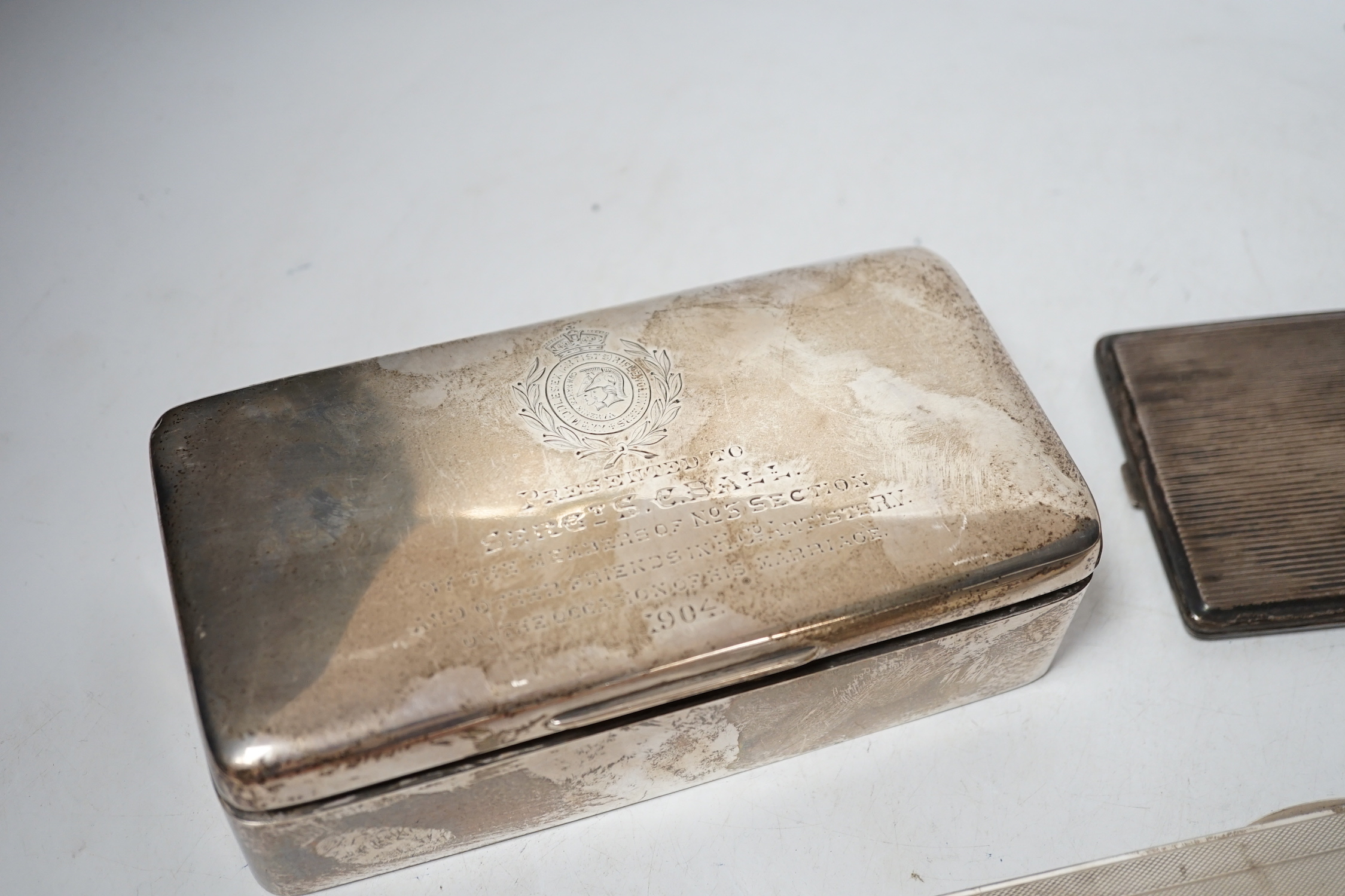 A 1930's engine turned silver cigarette box, 16.6cm, an Edwardian silver cigarette box and two silver cigarette cases.